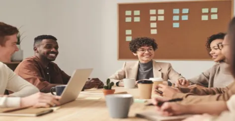 A diverse group of professionals laughing and discussing business matters