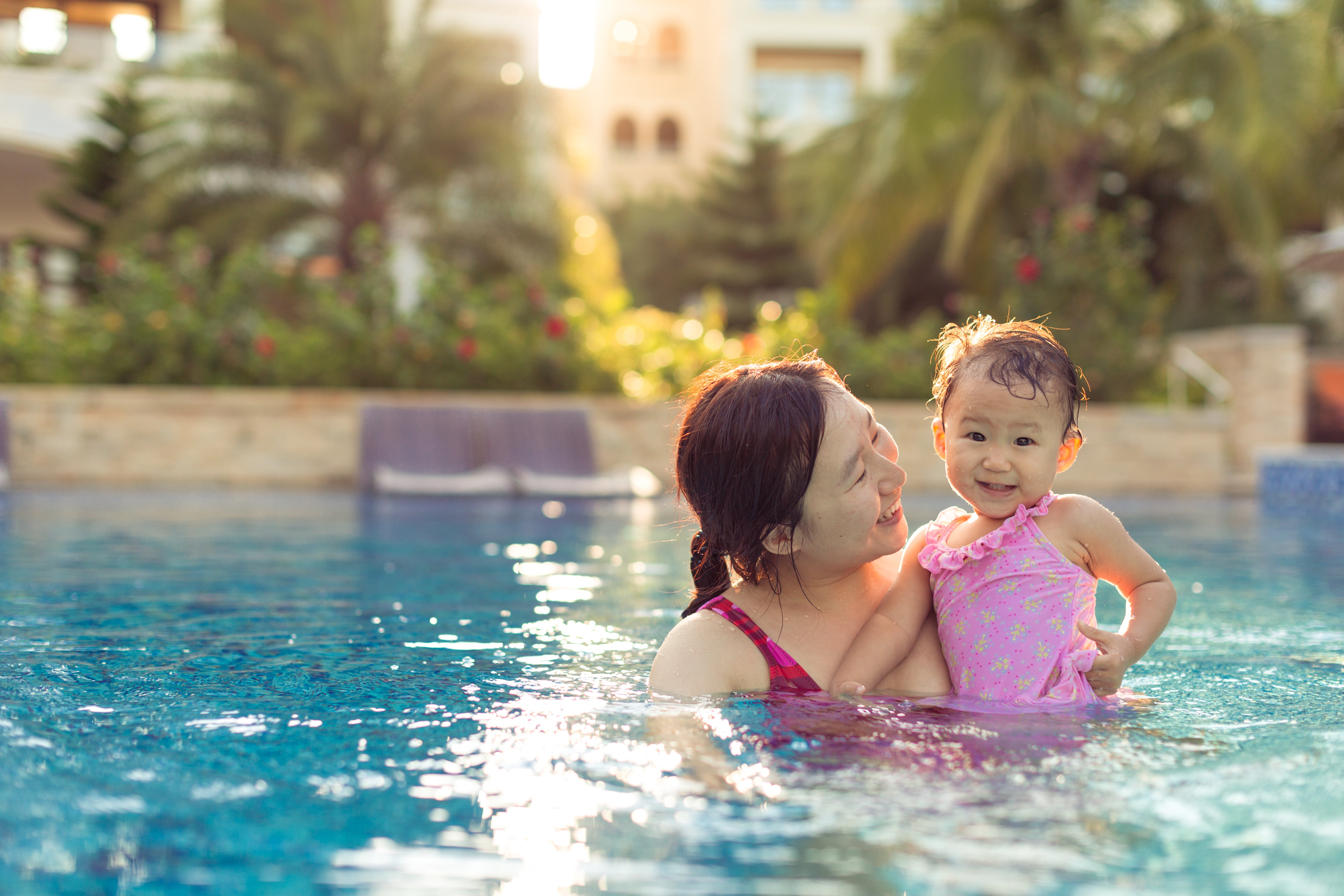 Baby and mom playing in swimming pool
