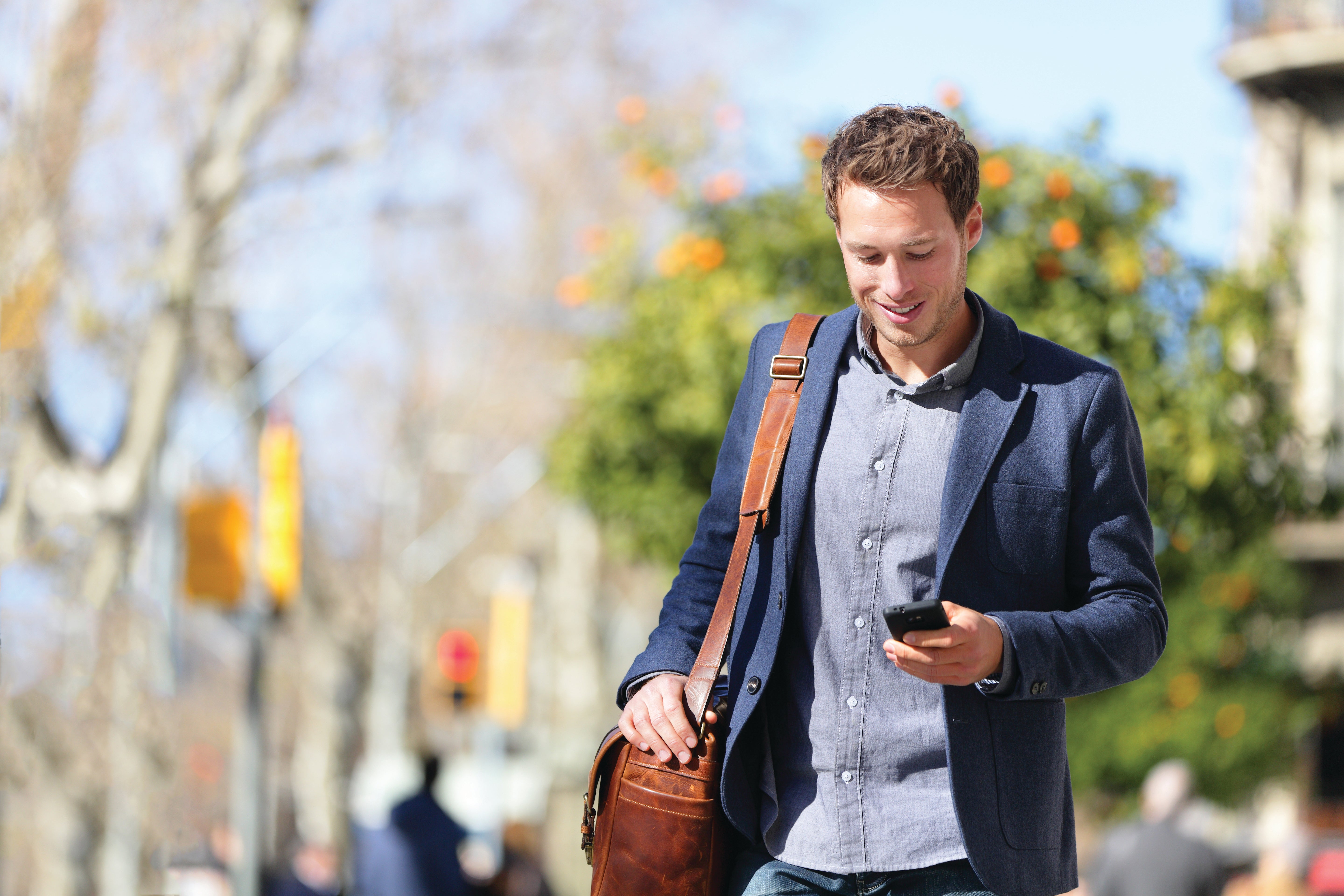 Young urban businessman professional on smartphone walking in street using mobile phone app texting sms message on smartphone wearing smart casual jacket. City lifestyle commute person walking.; Shutterstock ID 501680404; Job: none; Quickbase: none; Dept: none ; email: tom