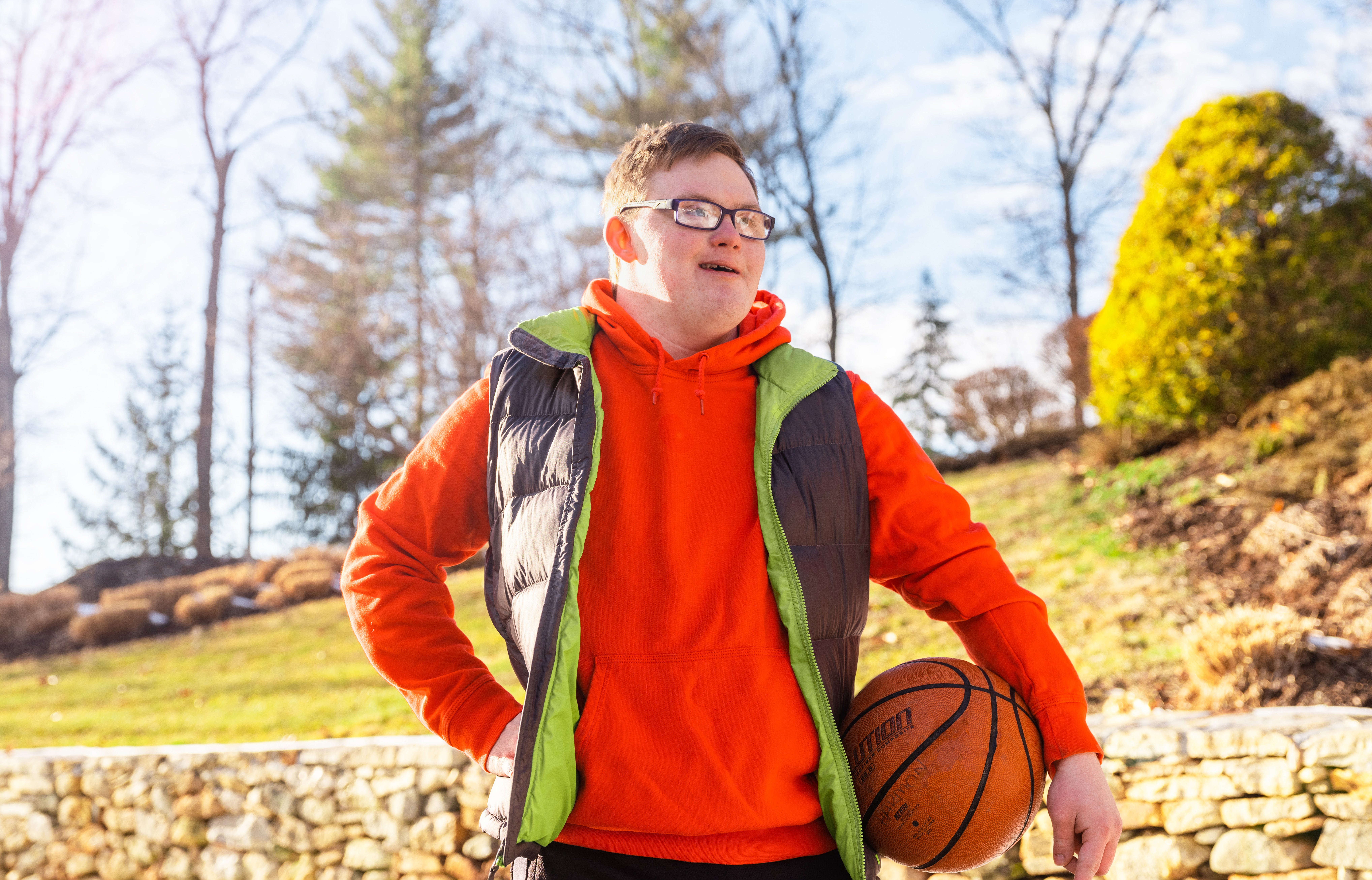 Harmon family son outdoors with basketball