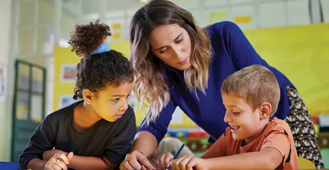 An elementary teacher working with two young children