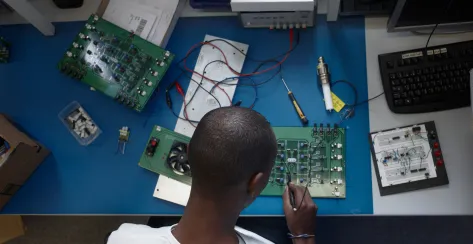 Birdseye view of African American electroncis engineer at workbench