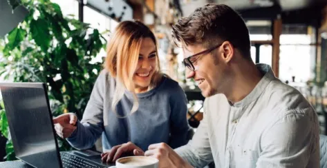 Young couple sitting in front of a computer doing their finances

