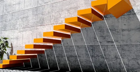 Orange stairs climb alongside a corporate office building