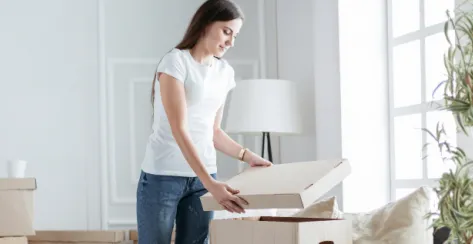 Woman organizing storage boxes in her home
